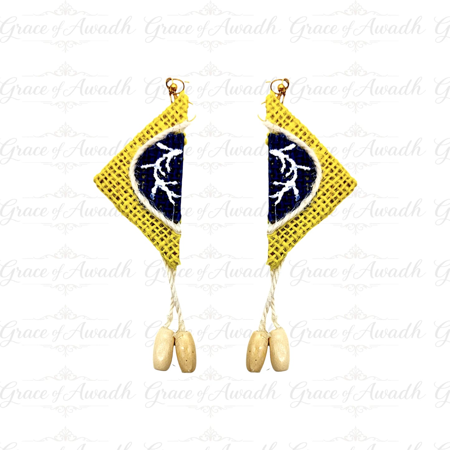 Pair of earrings with yellow diamond-shaped pendants and blue center on a white background. Noor-e-Baagh handcrafted yellow and blue fabric earrings with tassel drops – Grace of Awadh