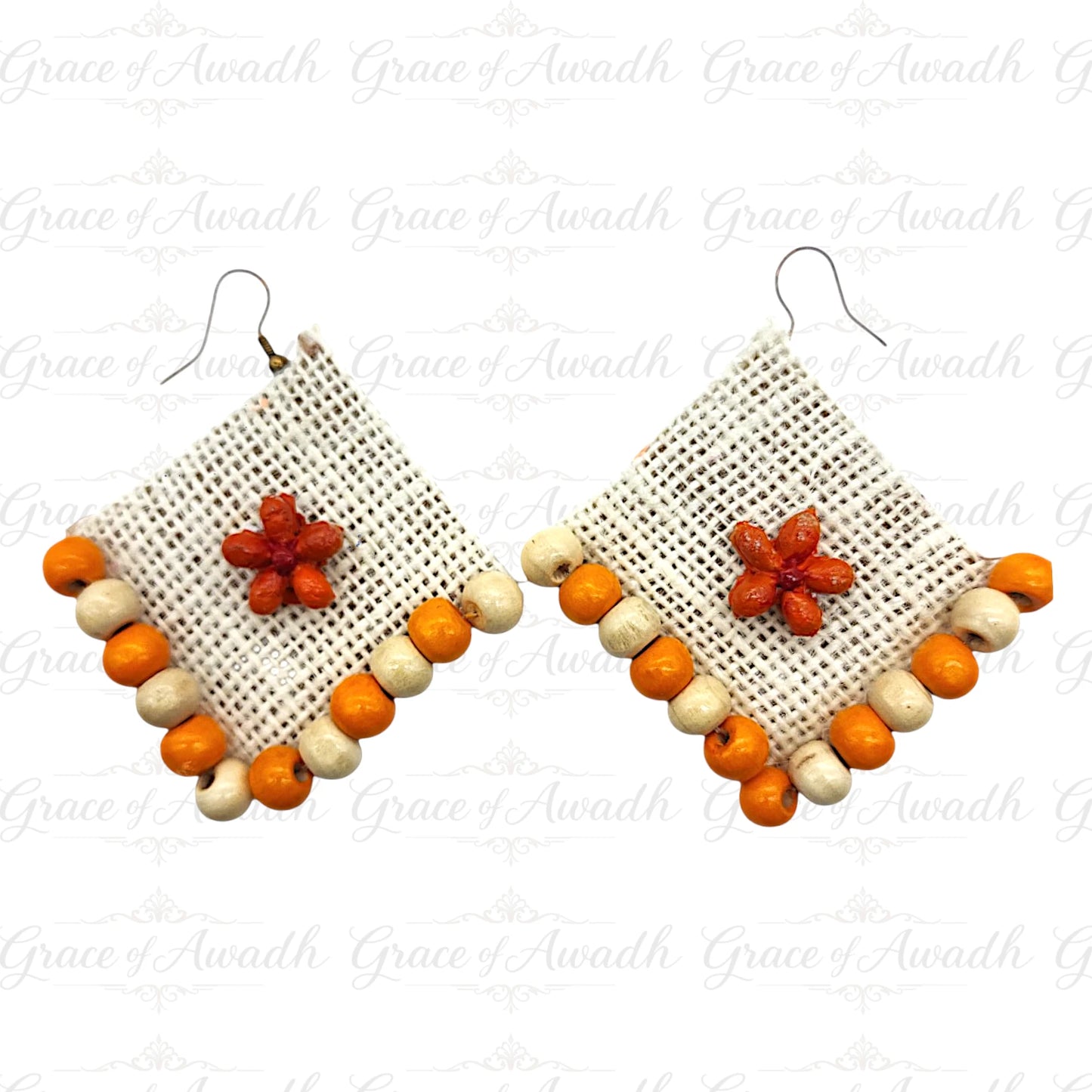 Pair of earrings with geometric design and colorful beads on a white Phool-e-Nazakat white fabric earrings with orange floral appliqué and orange beaded border – Grace of Awadhbackground.