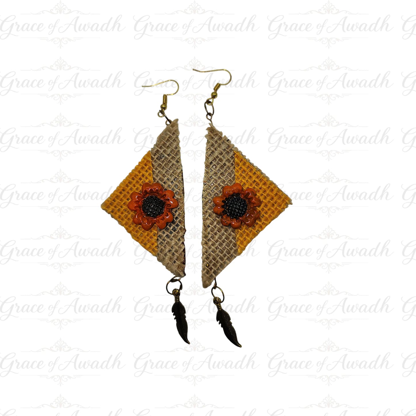Pair of earrings with geometric design and floral elements on a white background.
