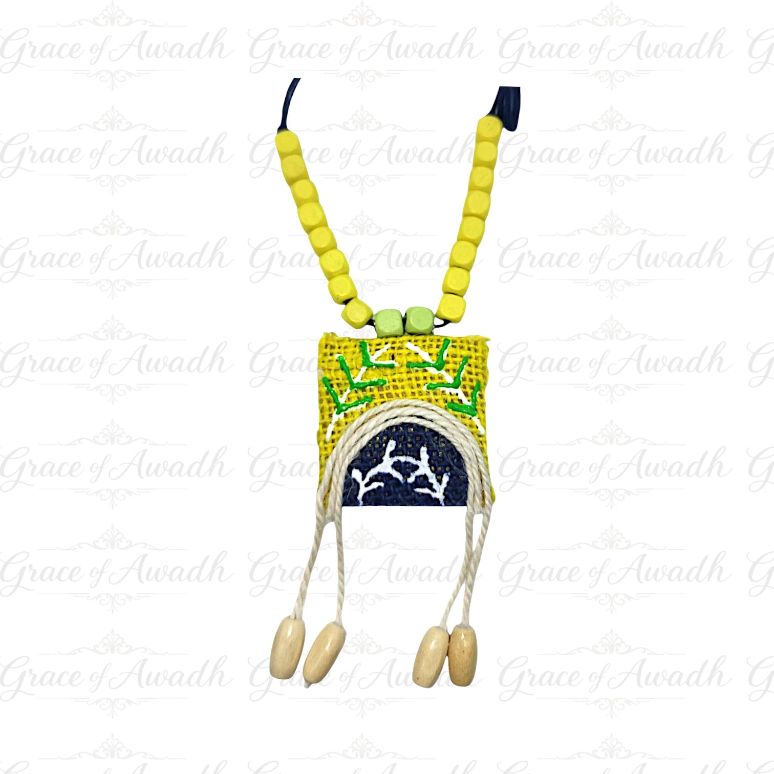 Necklace with yellow beads and a small pouch on a white background Noor-e-Baagh handcrafted yellow and blue fabric necklace with wooden beads and tassels – Grace of Awadh